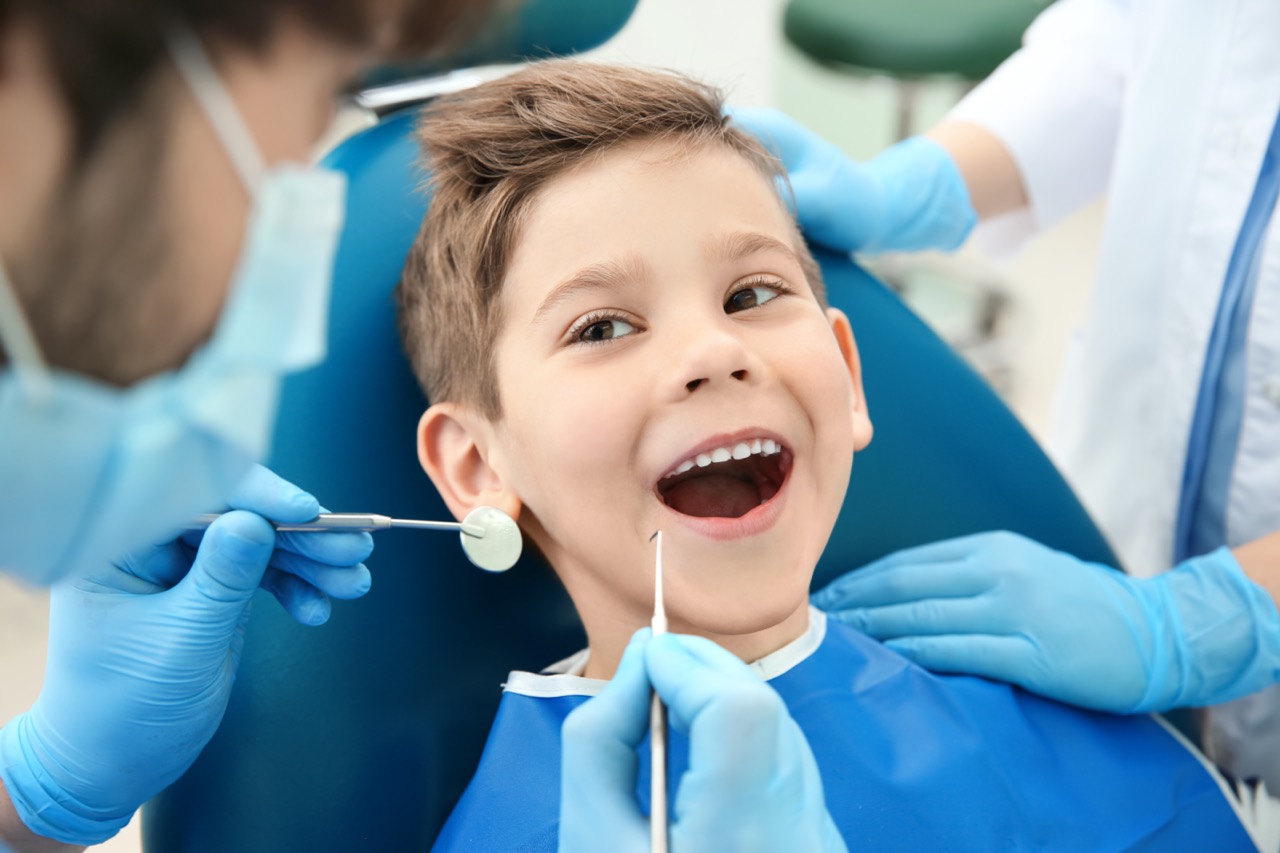 Dentist working with child at osha approved dental office
